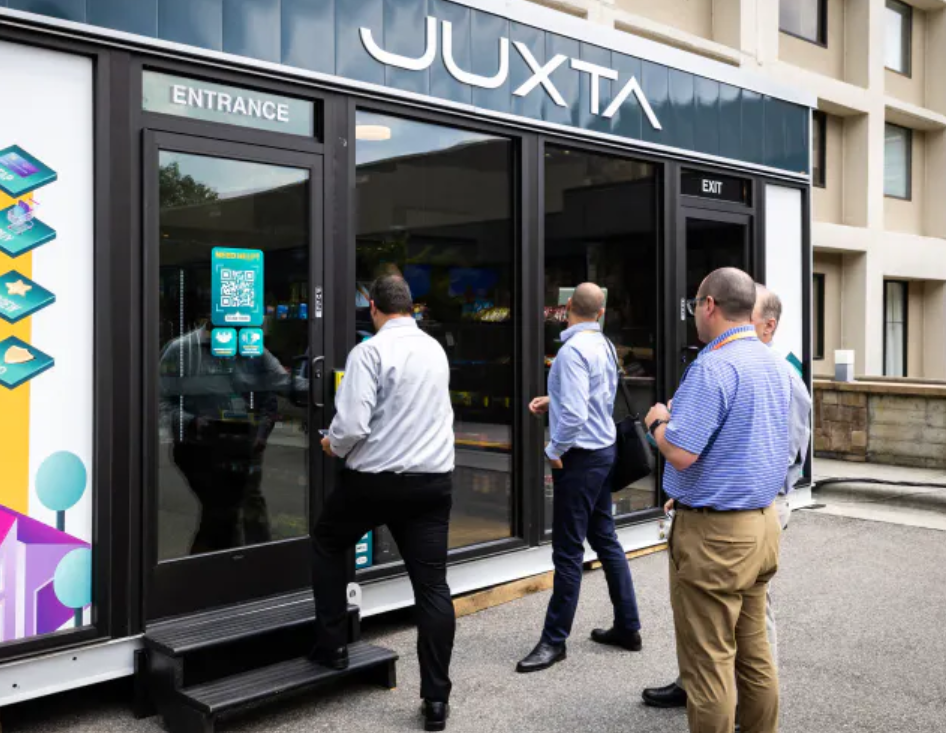 Four men entering Juxta offices